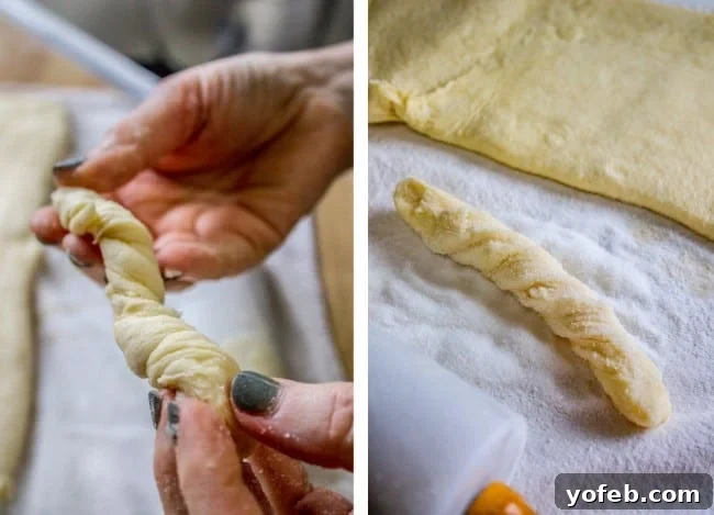 Swedish Layered Sour Cream Twists 14 raw dough held in one hand and on a pastry cloth, showing its pliable nature.