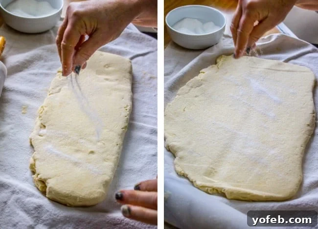 Swedish Layered Sour Cream Twists 9 rolled out dough being sprinkled by hand with sugar, demonstrating the generous application.