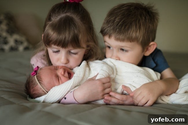Heartwarming Sibling Photo with a Newborn Sweet newborn sibling portrait
