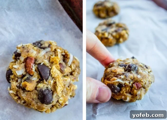 Skinny Texas Cowboy Cookies by The Food Charlatan. These low calorie cookies have NO sugar, NO white flour, and only 2 tablespoons of butter in the whole batch! What they do have are a ton of mix-ins. Oatmeal, coconut, bran flakes, pecans to name a few. They taste like a Texas Cowboy Cookie, but way better for you! (Which means I can eat half a batch...right?) #skinny #texascowboycookies #healthy #cookies #lowcalorie #nosugar #noflour #lowcarb #easy #recipes Dough for healthy oatmeal cookies being rolled by hand on a parchment-lined baking sheet, showcasing the easy, no-flour process.