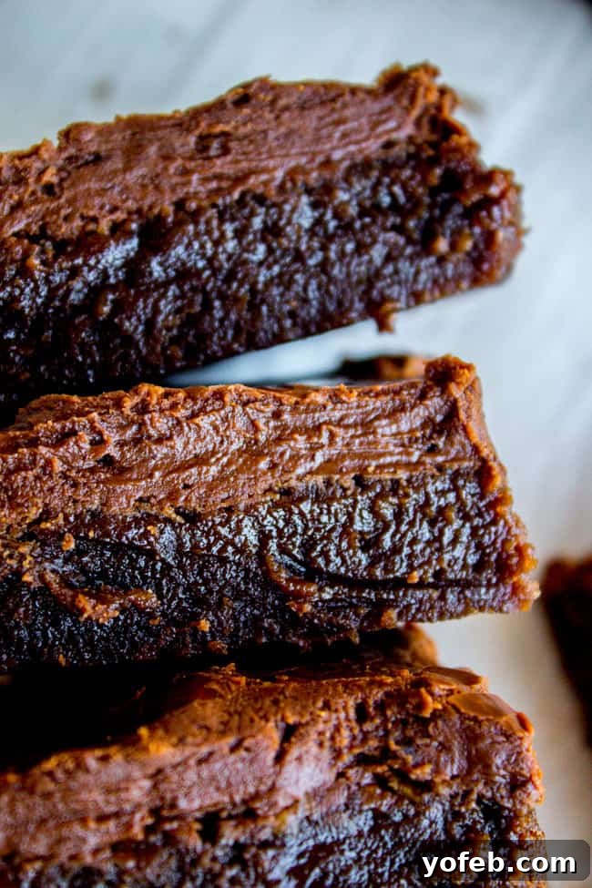 Nana's Legendary Fudgy Brownies 11 A stack of perfectly frosted fudge brownies, highlighting the thick, glossy frosting layer.