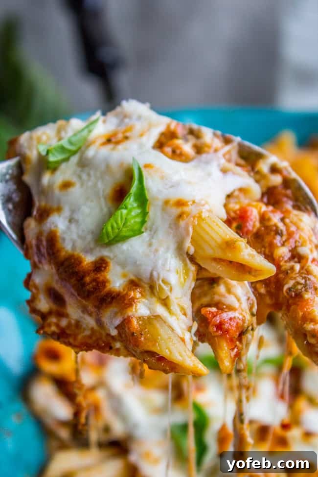 Supreme Cheesy Penne and Mozzarella Bake 9 A serving of Extra Cheesy Penne and Mozzarella Casserole, showcasing gooey cheese pull