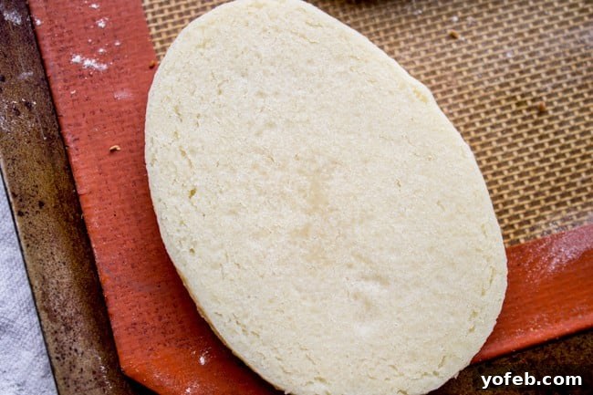 The Softest Sugar Cookies of Your Life from The Food Charlatan. A secret ingredient in this sugar cookies recipe makes these cookies the SOFTEST and most flavorful cookies of your life! And they even hold their shape after baking, so you get exactly what you want instead of sad blob cookies. #sugarcookies #cookies #frosting #soft #recipe #holiday #christmas #easter #halloween #fourthofjuly #stpatricksday #cookies #easy the underside of a freshly-baked cookie with a slightly undercooked center for extra softness.