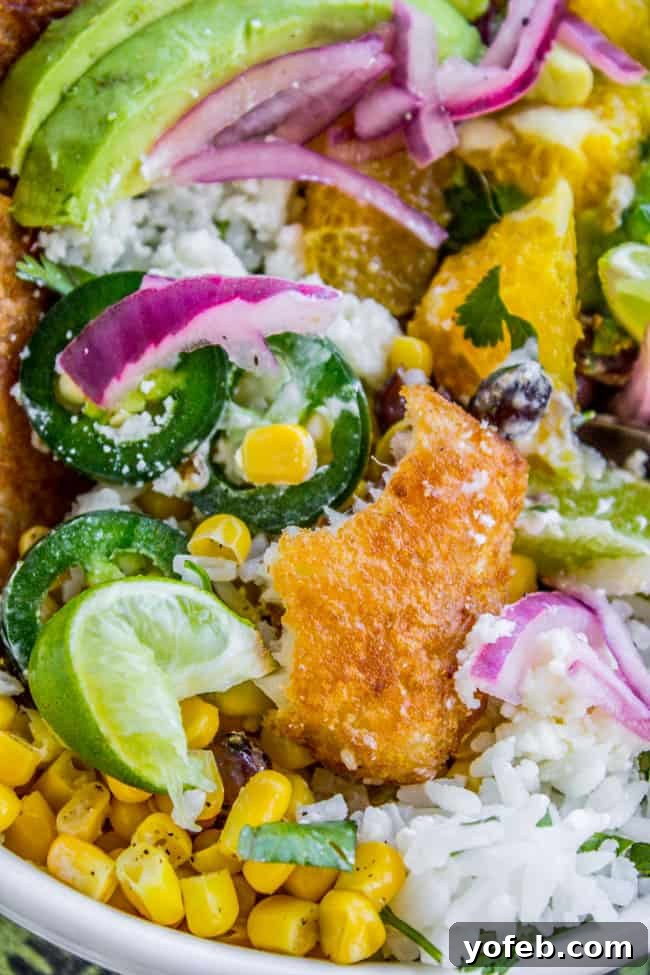 Crispy Beer-Battered Fish Burrito Bowl with Sunshine Avocado Salsa 13 A completed Beer-Battered-Fish Burrito Bowl with Orange Avocado Salsa, ready to eat