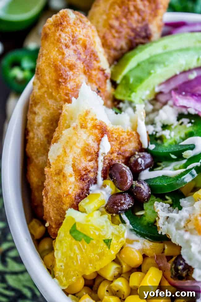Crispy Beer-Battered Fish Burrito Bowl with Sunshine Avocado Salsa 4 Close-up of a Beer-Battered-Fish Burrito Bowl with Orange Avocado Salsa from The Food Charlatan