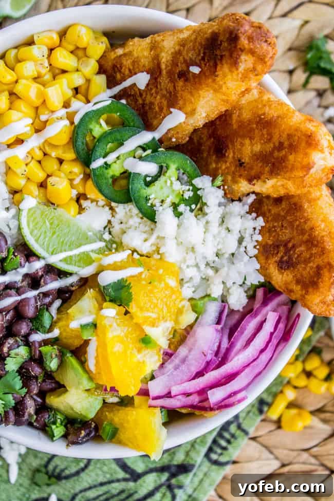 Crispy Beer-Battered Fish Burrito Bowl with Sunshine Avocado Salsa 5 Golden-brown Beer-Battered Fish Fillets, ready for a burrito bowl