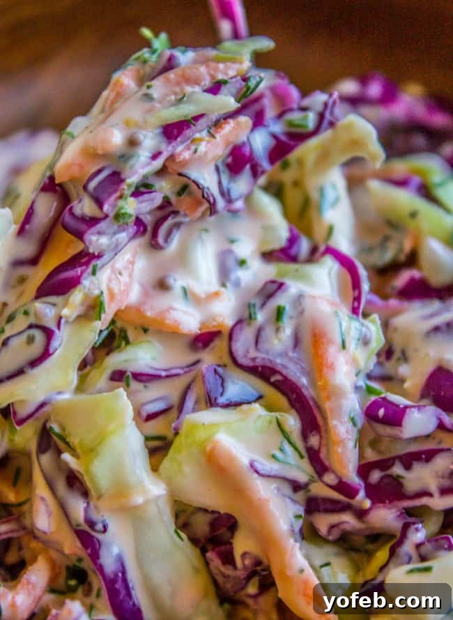 Zesty Lemon Herb Coleslaw 3 A close-up view of the vibrant lemon herb coleslaw in a serving bowl, showcasing the finely chopped herbs and shredded vegetables.