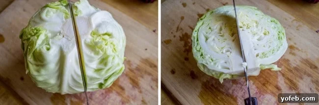 Zesty Lemon Herb Coleslaw 7 A wooden cutting board with a sharp knife slicing a vibrant green cabbage in half, illustrating the initial step for shredding coleslaw.