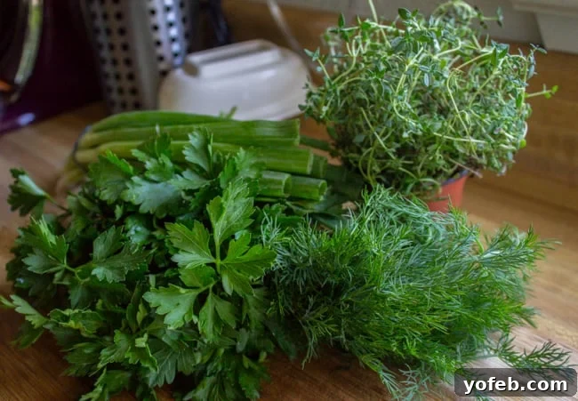 Zesty Lemon Herb Coleslaw 9 A vibrant selection of fresh herbs including parsley, chives, and thyme, neatly arranged on a wooden cutting board, ready for chopping.