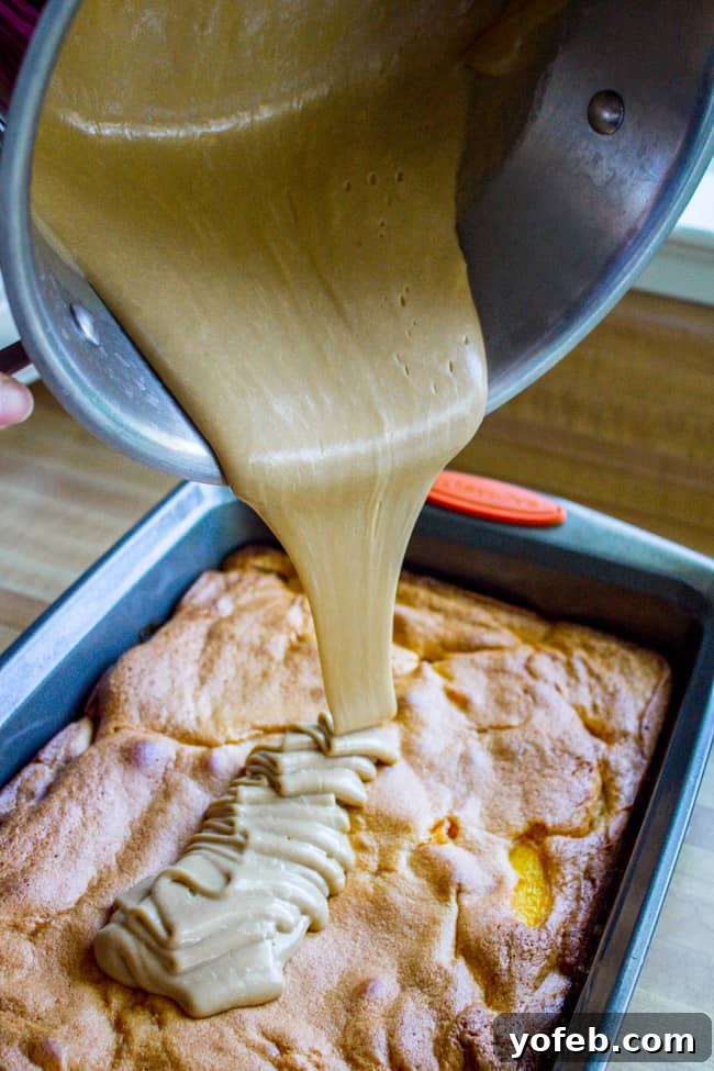 Velvet Peach Brown Sugar Dream 10 Pouring the thick, glossy brown sugar frosting over a cooled peach cake in a baking pan.