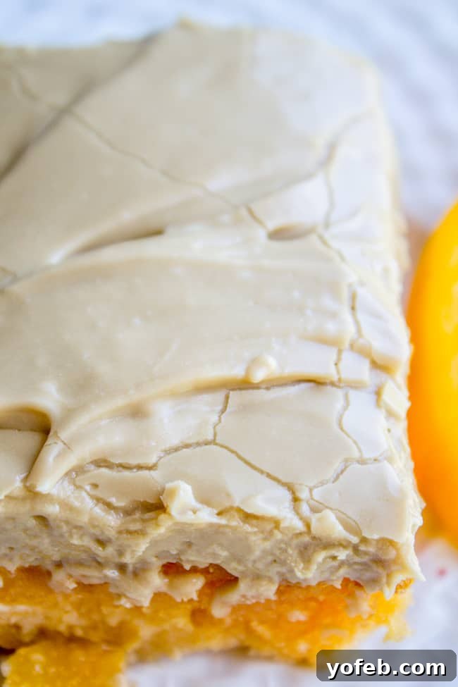 Velvet Peach Brown Sugar Dream 4 A whole peach cake generously coated with a smooth, glistening layer of brown sugar frosting, ready to be sliced.