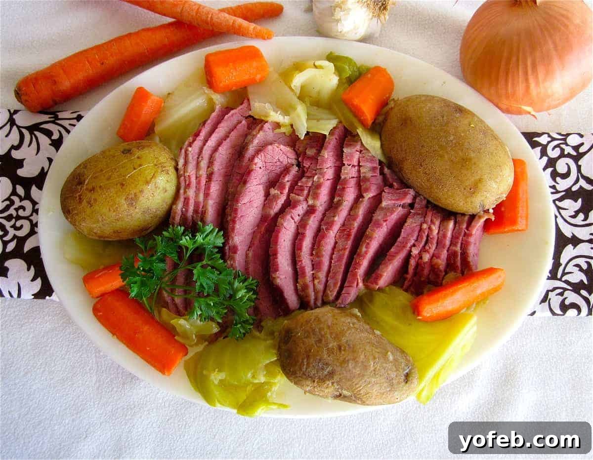 Ultimate Corned Beef Slow Cooker or Oven 21 A nostalgic photo of corned beef and cabbage on a plate, featuring a fuzzy white blanket as a backdrop, humorously reflecting early food photography attempts.