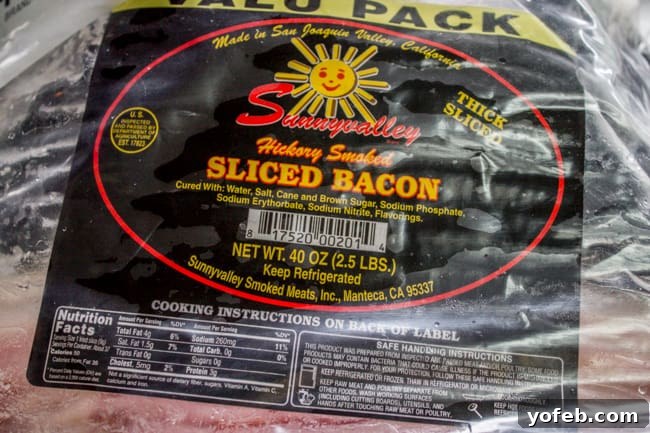How to Bake Bacon in the Oven in 12 Minutes from the Food Charlatan. I literally never make bacon on the stove anymore. It is SO much easier cooking bacon in the oven than to stand over a hot stove getting splattered with grease. And you can make a whole pan at a time, making it great for a crowd. You can even make it ahead! Let me show you how to bake bacon - it's simple. #bakingbacon #bacon #intheoven #howto #crispy #breakfast #simplerecipe #cookiesheets #350 #lowcarb #comfortfoods A packaged of artisanal, thick-cut bacon, showcasing its quality and freshness.