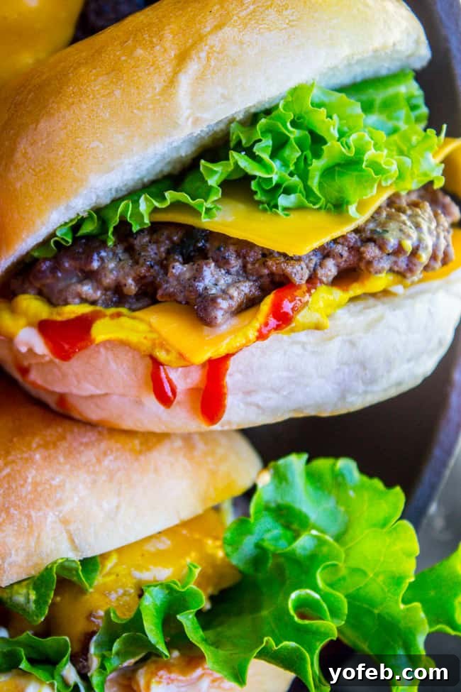 The Perfect Handheld Smash Burger A hand presenting a beautifully crafted smash burger, inviting a delicious bite.