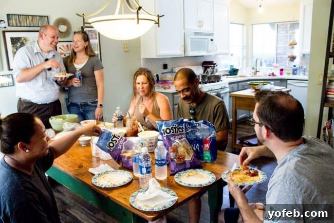 Salsa in 5: Restaurant Flavor for Your Best Taco Tuesday Yet 8 Friends gathered at the kitchen table to enjoy a meal together.