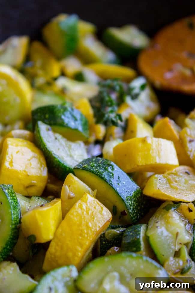 Effortless 10-Minute Zucchini Squash Side 2 Vibrant sautéed zucchini and yellow squash generously seasoned with fresh thyme, presented beautifully in a serving dish, ready to be enjoyed as a healthy and quick side dish.
