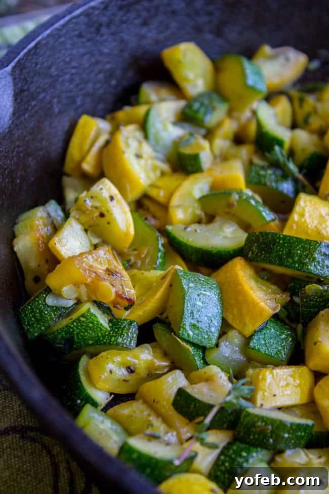 Effortless 10-Minute Zucchini Squash Side 3 A vibrant blue bowl filled with perfectly sautéed zucchini and yellow squash, lightly seasoned with fragrant thyme, promising a delightful and easy side dish.