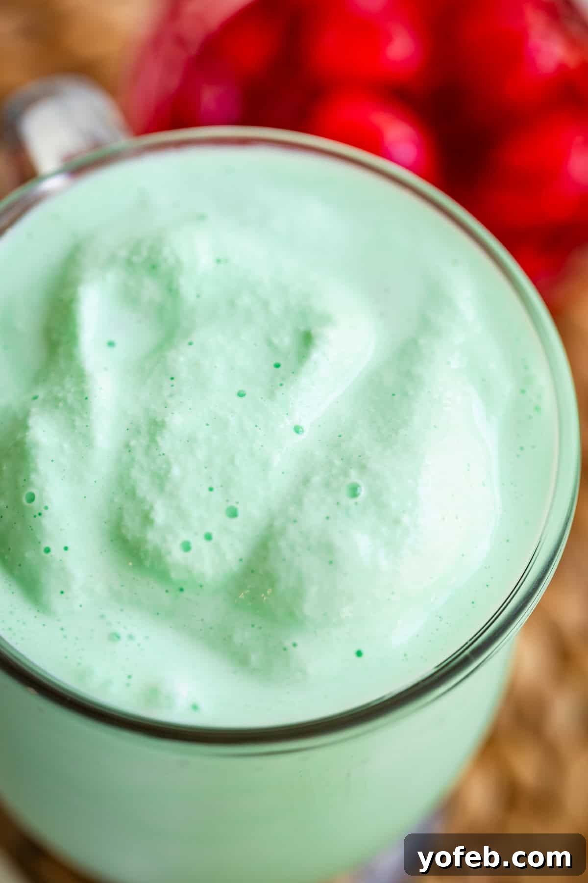 Leprechaun's Delight Shake 16 A glass mug filled to the very brim with a creamy, smooth Shamrock Shake, emphasizing its rich and indulgent texture.