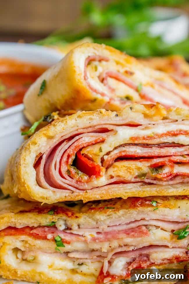 The Ultimate Homemade Stromboli 2 stromboli sliced on a plate shot closeup.