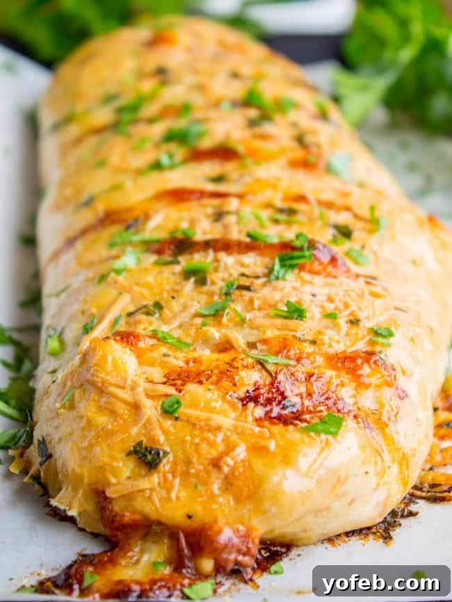 The Ultimate Homemade Stromboli 4 Stromboli with browned cheese and fresh parsley on top.