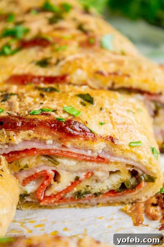 The Ultimate Homemade Stromboli 9 Sliced meat and cheese filled stromboli topped with fresh parsley.