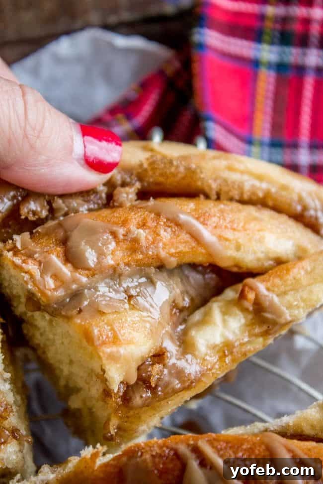 Maple Butter Morning Twist 14 A slice of the warm, glazed Maple Butter Twist Coffee Cake, revealing its soft interior and gooey maple filling.
