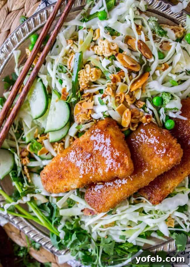 Crispy Fish atop Zesty Asian Slaw 2 Crunchy Asian Cabbage Salad with Crispy Fish from The Food Charlatan - A vibrant and fresh dish.
