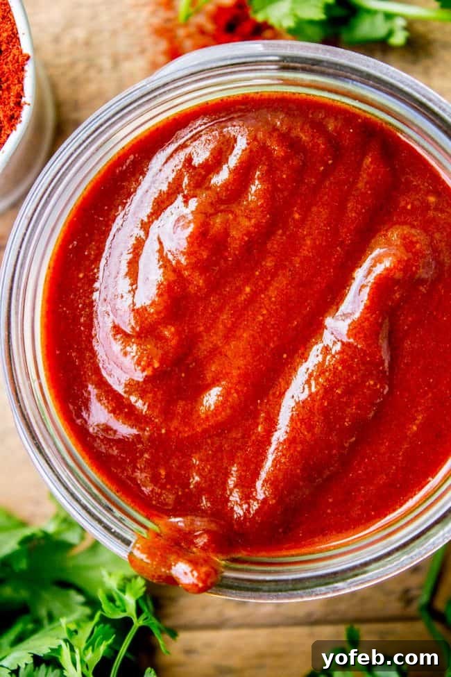 Speedy Homemade Enchilada Sauce 4 A mason jar filled with freshly made, vibrant red enchilada sauce, ready for storage or immediate use.