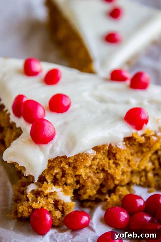 Decadent Pumpkin Squares with Cream Cheese Frosting 2 Paul's Pumpkin Bars with Cream Cheese Frosting topped with red hot candies, a quintessential fall dessert.