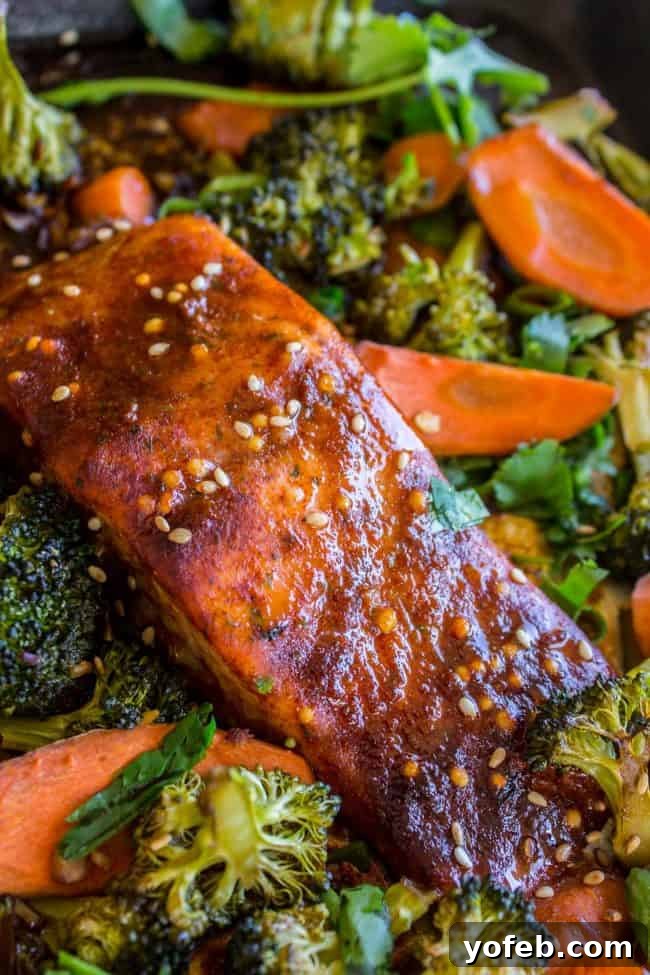 One Pan Asian Sesame Salmon with Noodles and Roasted Veggies 3 Close-up of roasted broccoli and carrots with Asian sauce on a sheet pan