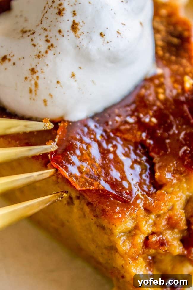 A Decadent Pumpkin Pie with Crème Brulée 4 A fork touching the creme brulee topping on a creamy pumpkin pie with whipped cream.