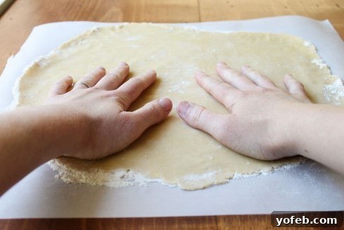 A Decadent Pumpkin Pie with Crème Brulée 8 hands patting a rolled out pie crust.