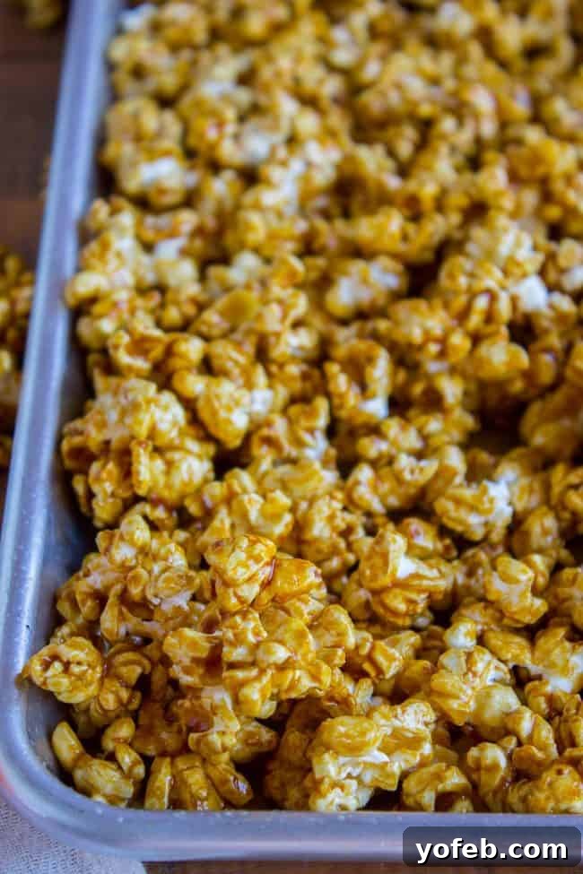 Homemade Caramel Popcorn Batch A generous batch of homemade caramel corn in a large metal mixing bowl, ready to be portioned or served.