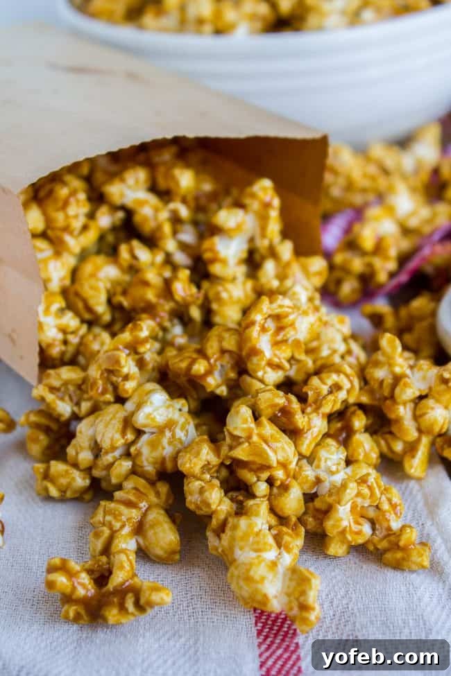 Caramel Popcorn Ready to Serve Homemade caramel popcorn overflowing from a brown paper bag, showcasing its golden kernels and rich coating, ready for serving.