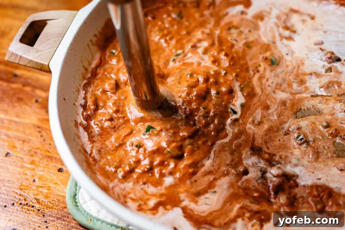 Chicken Tikka Masala A Culinary Revelation 13 an immersion blender stuck into the pan with unblended sauce.