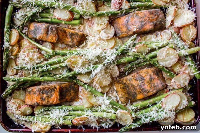 Sheet Pan Salmon with Creamy Scalloped Potatoes and Asparagus from The Food Charlatan. Don't you just love sheet pan dinners?? They are so easy and there's only ONE DISH to wash! This Citrus Herb Salmon is paired with creamy scalloped potatoes and fresh asparagus to make a super easy, pretty healthy, and DELICIOUS one pan meal. #dinner #asparagus #sheetpan #onepan #salmon #lemon #healthy #roastedsalmon #easy #quick #herb #potatoes #creamy #recipe #mealprep #weeknight #salmonrecipesbaked #salmondinner #onesheetpanmeals #sheetpanmeals Sheet pan salmon with roasted asparagus and potatoes