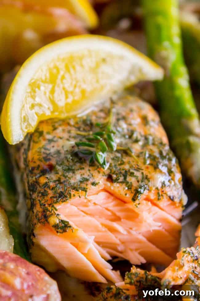 Sheet Pan Salmon with Creamy Scalloped Potatoes and Asparmergus from The Food Charlatan. Don't you just love sheet pan dinners?? They are so easy and there's only ONE DISH to wash! This Citrus Herb Salmon is paired with creamy scalloped potatoes and fresh asparagus to make a super easy, pretty healthy, and DELICIOUS one pan meal. #dinner #asparagus #sheetpan #onepan #salmon #lemon #healthy #roastedsalmon #easy #quick #herb #potatoes #creamy #recipe #mealprep #weeknight #salmonrecipesbaked #salmondinner #onesheetpanmeals #sheetpanmeals Salmon sheet pan dinner