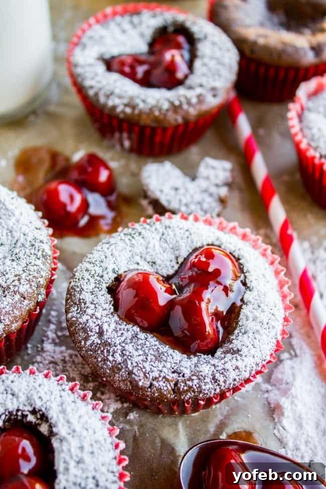 Beautifully arranged Valentine's Day Cupcakes with cherry heart centers.