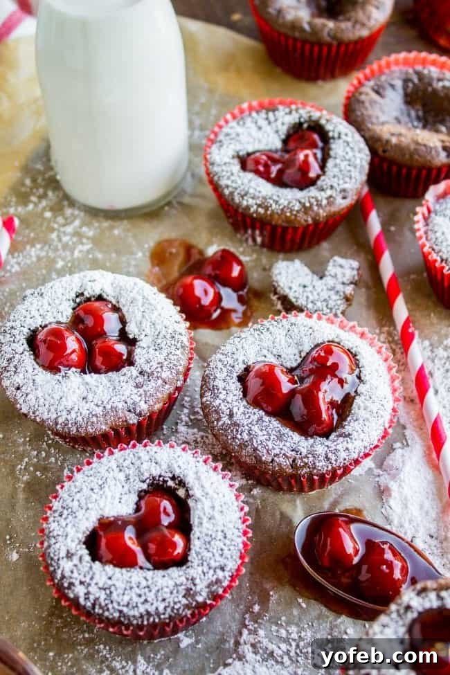 Final presentation of Chocolate Cheesecake Cupcakes with glistening cherry filling.