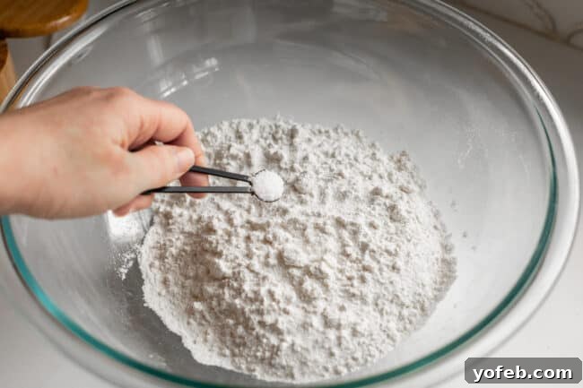 Roti Buttery Indian Flatbread Perfection 13 adding salt to a large bowl of bread flour.