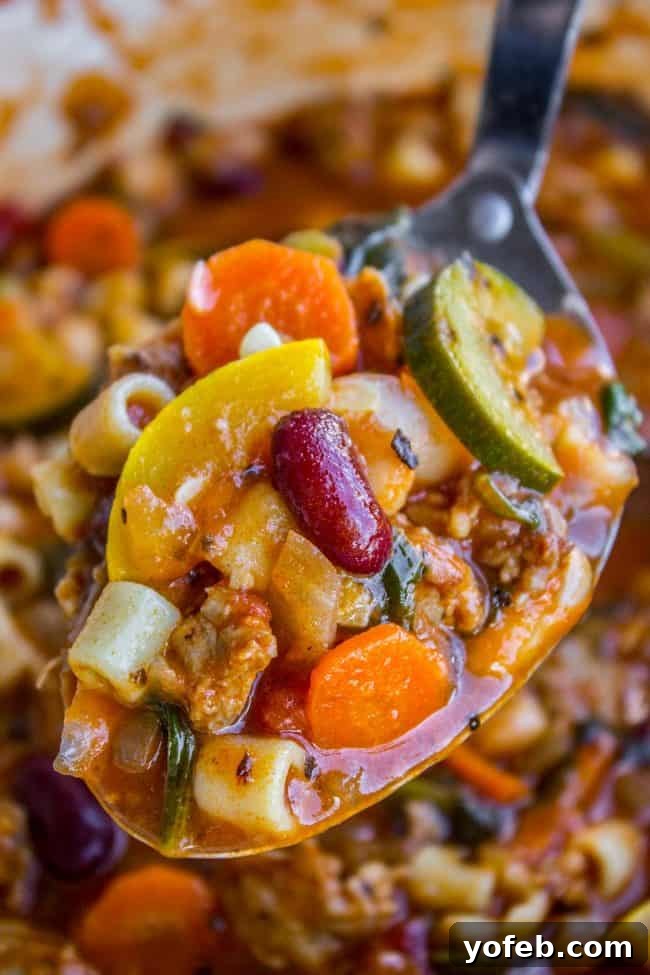 Delicious Spoonful of Hearty Minestrone Soup spoonful of minestrone soup with beans.