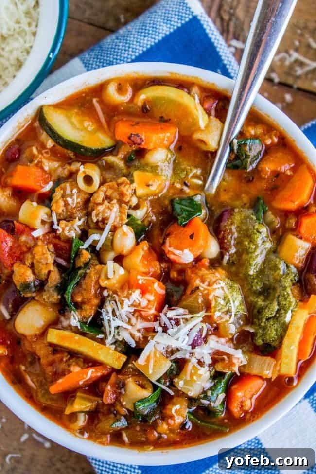 Comforting Bowl of Minestrone Soup Ready to Enjoy minestrone soup in a bowl with a spoon.