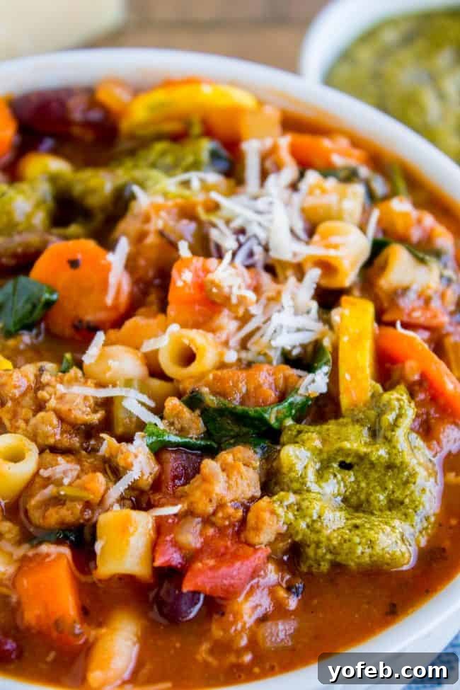 Gourmet Minestrone Bowl with Pesto and Sausage minestrone soup with pesto and sausage in a bowl.