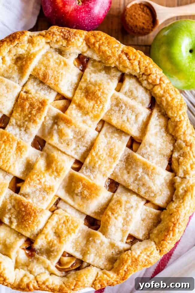 Grandma's Secret Apple Pie 3 A beautifully crafted apple pie with a lattice crust, showcasing golden-brown edges and a tempting filling peeking through.