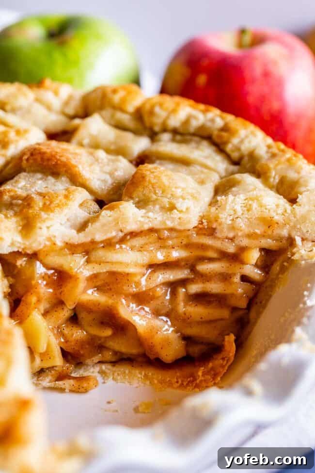 Grandma's Secret Apple Pie 4 A tall, perfectly baked apple pie with a golden-brown crust, a slice beautifully cut out, revealing the rich apple filling inside.