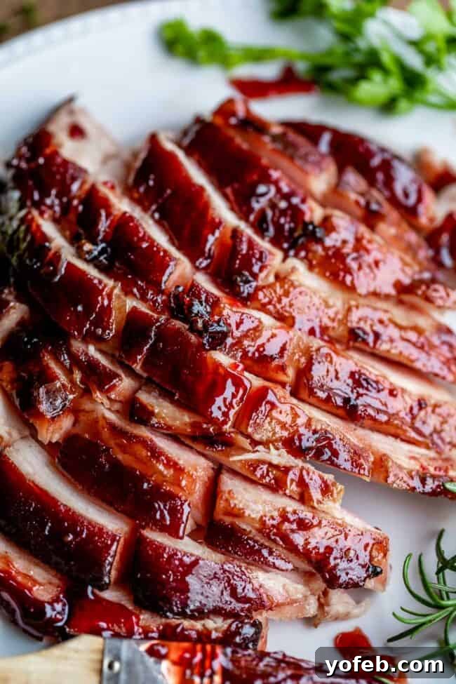 Juicy Baked Ham with Raspberry Chipotle Glaze Raspberry Chipotle Glazed Baked Ham on a platter