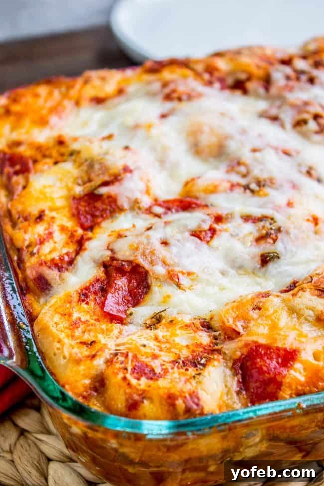 Ultimate Easy Pizza Casserole Recipe Close-up of a bubbling Easy Pizza Casserole, showcasing the golden biscuit crust and cheesy topping.
