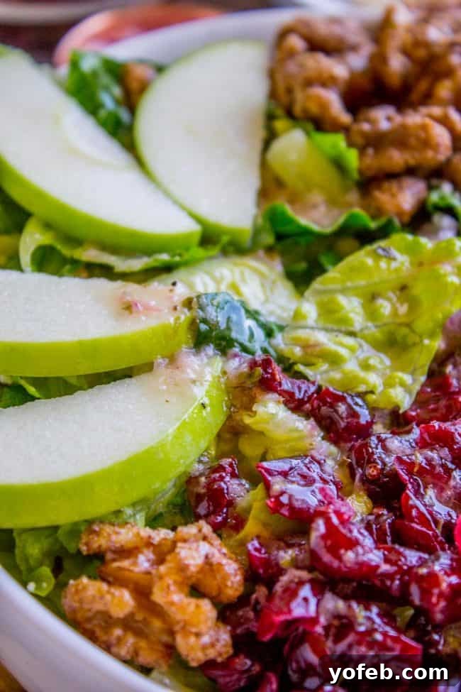 Homemade Buca di Beppo Apple Gorgonzola Salad 4 Various ingredients for the Apple Gorgonzola Salad laid out, including romaine, apples, gorgonzola, and cranberries, ready for assembly.