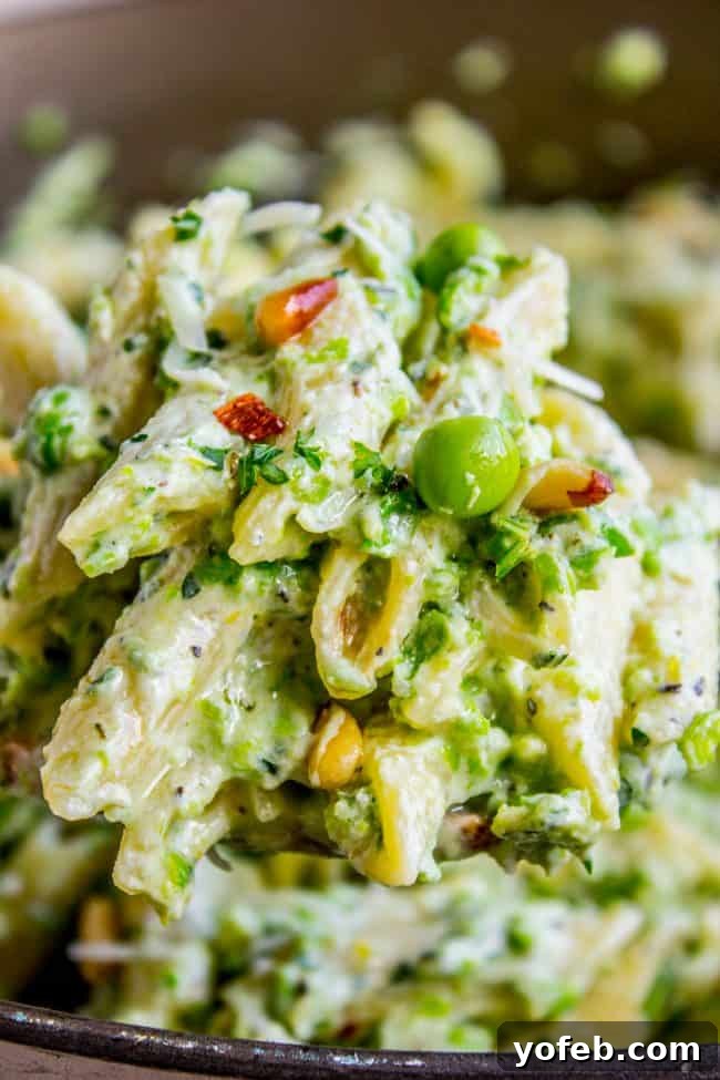 Lemon Ricotta Pasta with Fresh Peas (30 Minutes) from The Food Charlatan. This lemon pasta recipe is perfect for summer! It is so easy and done in 30 minutes. The cheesy sauce is made by blending ricotta with peas and lemon. Top it with Parmesan and garden fresh peas, and you have a hearty vegetarian dinner! It's so good! #pasta #lemonpasta #ricotta #ricottapasta #peas #freshpeas #pinenuts #summer #easy #easyrecipe #30minutes #parmesan #garlic #creamy #sauce #healthy #vegetarian #onepot Creamy ricotta pasta with green peas and a drizzle of olive oil, ready to be served