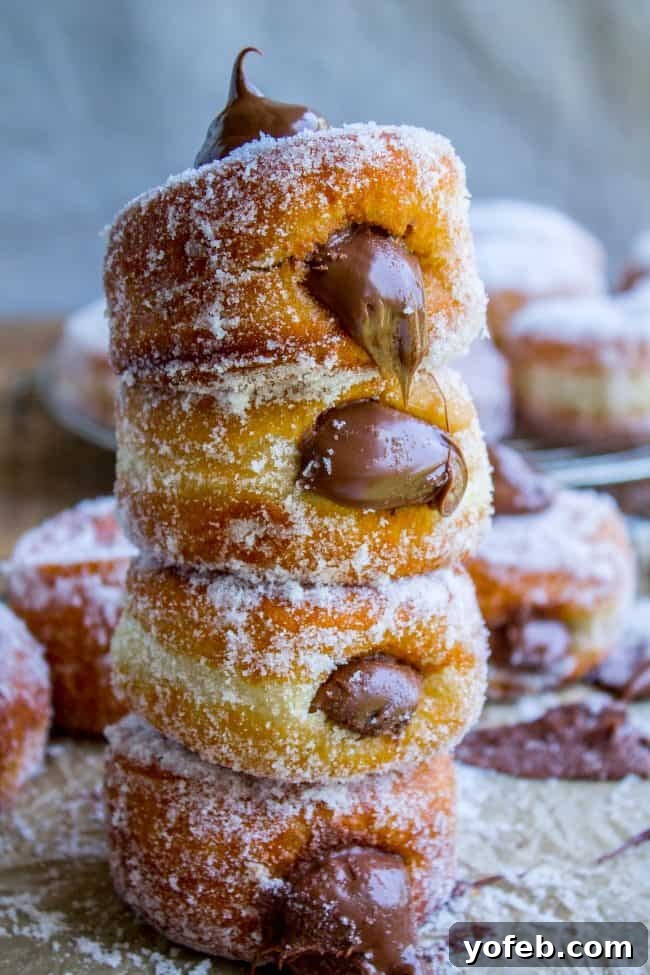 Master the art of homemade stuffed donuts with this easy-to-follow Nutella donut recipe. Achieve incredibly soft and puffy yeast donuts, perfect for any occasion. Close-up of a perfectly fried homemade stuffed donut, showcasing its light golden exterior and soft, airy texture, ready for a delicious filling.